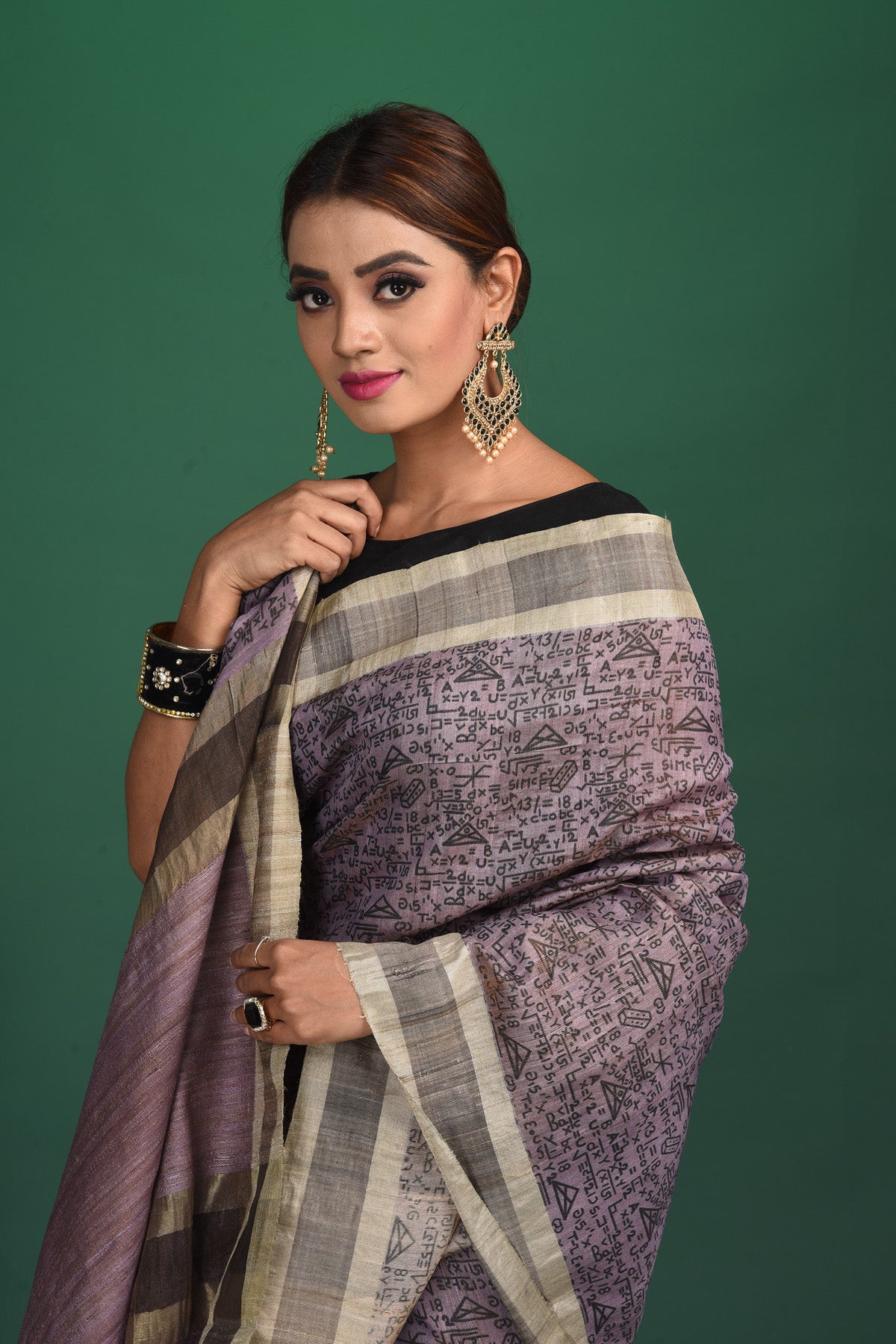 Shop this exquisite lavender purple tussar saree with purple vidharbha border online in USA which is handcrafted from fine silk tussar fabric, this tie and dye saree brings out the nature of flow. This tussar saree with elegant purple Vidharbha border is making everyone swoon over it. Make it yours and flaunt a handwoven marvel with minimal jewellery for a casual day outfit. Add this pure tussar saree to your collection from Pure Elegance Indian fashion store in USA.-Close up.