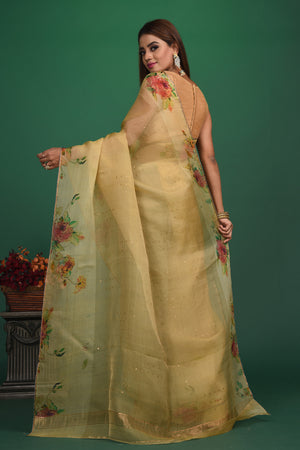 Buy this royal handcrafted weaving saree in cotton silk in light yellow color online in USA. It also has a Pallu with bronze weave and fringes. The entire saree has a Golden border and enhance with a beautiful floral pattern.  Make it yours and flaunt a handwoven marvel with minimal jewellery for a casual day outfit. Add this coton silk saree to your collection from Pure Elegance Indian fashion store in USA.-Back view with open pallu.