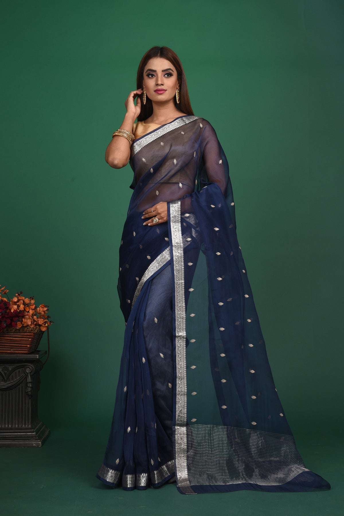 Buy this elegant dark blue soft organza designer saree with silver zari work on heavy border online in USA. Organza silk fabric is a type of silk cloth that is crisp, translucent, and extremely light in weight. It is used to make organza silk saree, drapes, and other decorative pieces. Add this designer sari to your collection from Pure Elegance Indian fashion store in USA.-Full view with open pallu.