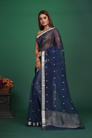 Buy this elegant dark blue soft organza designer saree with silver zari work on heavy border online in USA. Organza silk fabric is a type of silk cloth that is crisp, translucent, and extremely light in weight. It is used to make organza silk saree, drapes, and other decorative pieces. Add this designer sari to your collection from Pure Elegance Indian fashion store in USA..-Side view with open pallu.