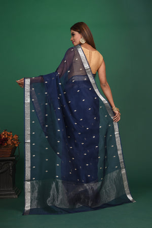 Buy this elegant dark blue soft organza designer saree with silver zari work on heavy border online in USA. Organza silk fabric is a type of silk cloth that is crisp, translucent, and extremely light in weight. It is used to make organza silk saree, drapes, and other decorative pieces. Add this designer sari to your collection from Pure Elegance Indian fashion store in USA.-Back view with open pallu.