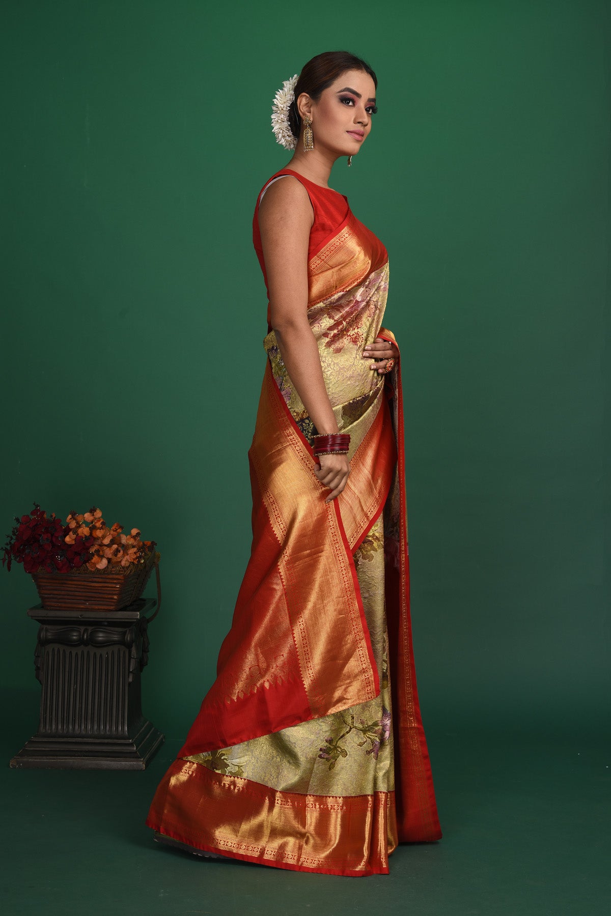 Buy this exquisite pista green Silk handloom Banarasi Saree with red-gold Zari Brocade all over online in USA which has delicate Gold zari Meenakari work a gold Zari border and heavy brocade pallu. Wear this banarasi silk designer saree for your special days with a mini potli bag from Pure Elegance Indian fashion store in USA.-Side view.