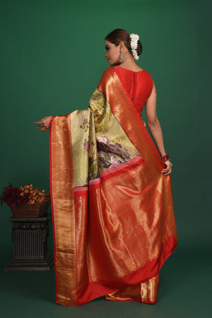 Buy this exquisite pista green Silk handloom Banarasi Saree with red-gold Zari Brocade all over online in USA which has delicate Gold zari Meenakari work a gold Zari border and heavy brocade pallu. Wear this banarasi silk designer saree for your special days with a mini potli bag from Pure Elegance Indian fashion store in USA.-Back view with open pallu.
