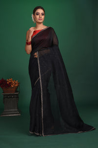 Shop this exquisite black saree in soft organza with heavy lace border online in USA which is made of organza fabric and lightweight. This organza Saree is beautified with lace work and latest trend. Ideal for casual, kitty parties, stylish accessories. Shop this from Pure Elegance Indian fashion store in USA.-Full view.