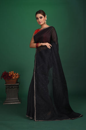 Shop this exquisite black saree in soft organza with heavy lace border online in USA which is made of organza fabric and lightweight. This organza Saree is beautified with lace work and latest trend. Ideal for casual, kitty parties, stylish accessories. Shop this from Pure Elegance Indian fashion store in USA.-Full view with folded hands.