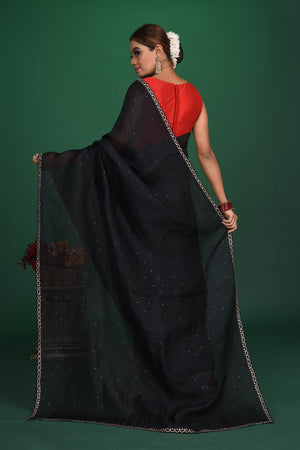Shop this exquisite black saree in soft organza with heavy lace border online in USA which is made of organza fabric and lightweight. This organza Saree is beautified with lace work and latest trend. Ideal for casual, kitty parties, stylish accessories. Shop this from Pure Elegance Indian fashion store in USA.-back view with open pallu.
