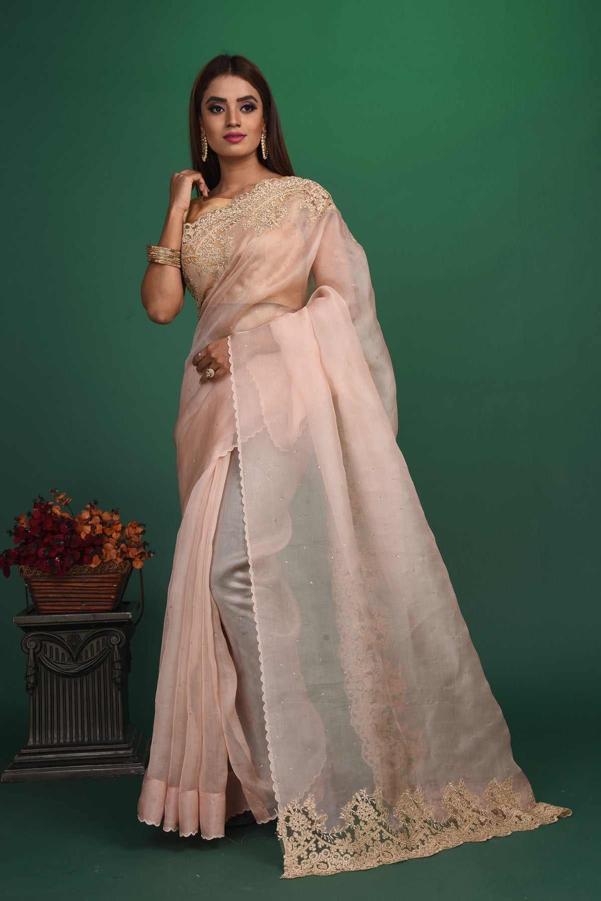 Buy this elegant baby pink designer saree in soft organza with heavy golden embroidered border online in USA which is made of organza fabric and lightweight. This organza Saree is beautified with embroidered work and latest trend. Ideal for casual, kitty parties, stylish accessories. Shop this from Pure Elegance Indian fashion store in USA.-Full view with open pallu.
