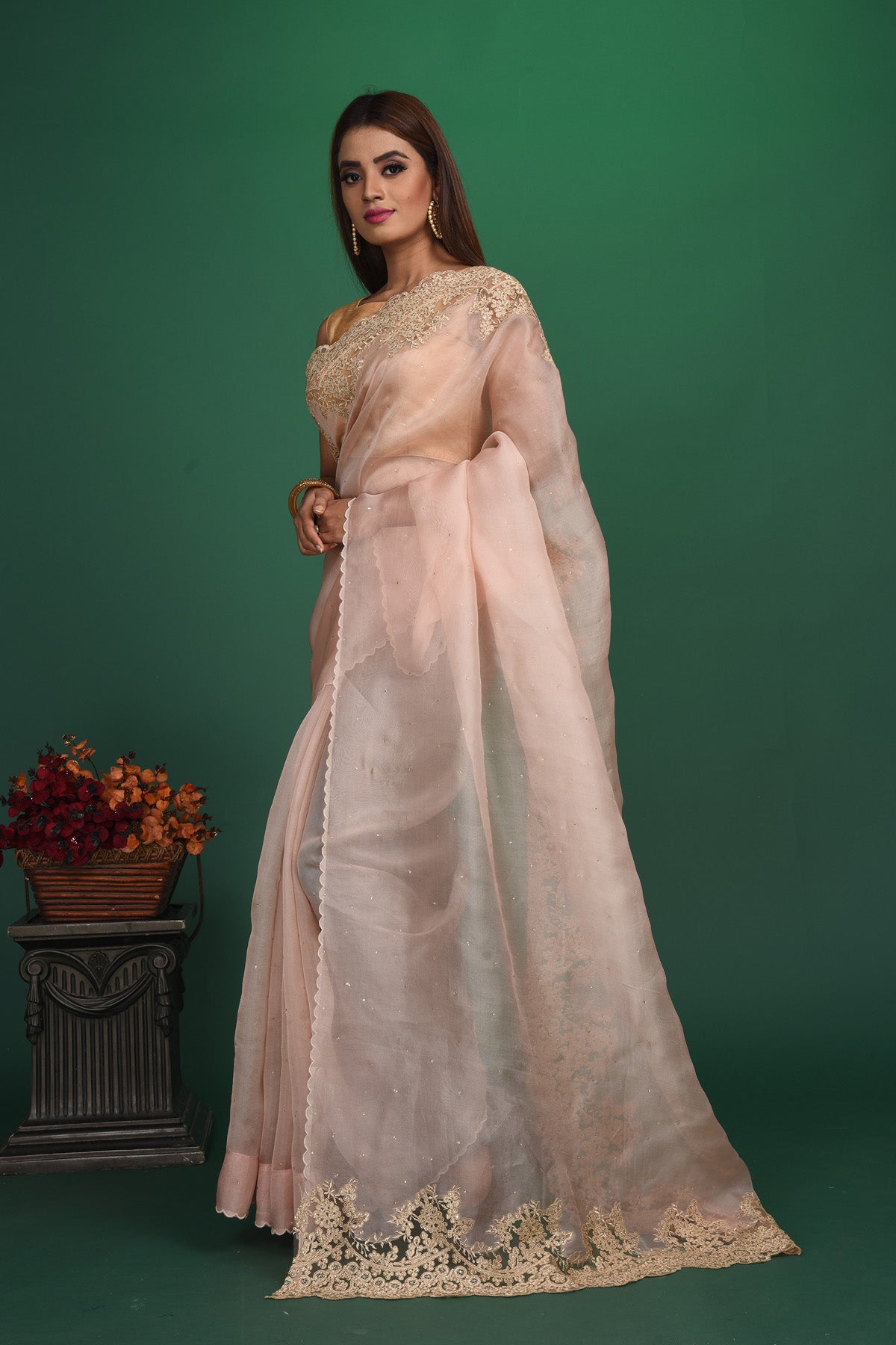 Buy this elegant baby pink designer saree in soft organza with heavy golden embroidered border online in USA which is made of organza fabric and lightweight. This organza Saree is beautified with embroidered work and latest trend. Ideal for casual, kitty parties, stylish accessories. Shop this from Pure Elegance Indian fashion store in USA.-Side view with open pallu.