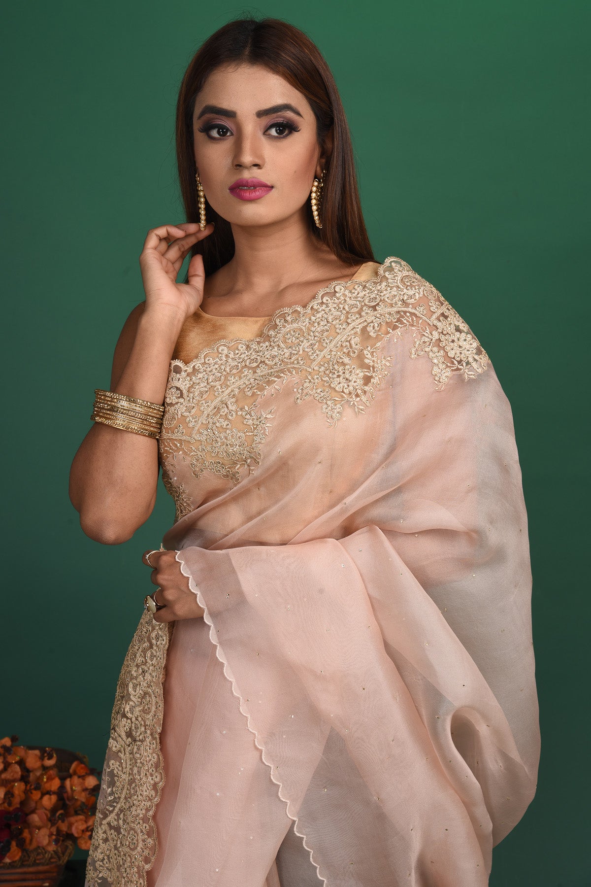 Buy this elegant baby pink designer saree in soft organza with heavy golden embroidered border online in USA which is made of organza fabric and lightweight. This organza Saree is beautified with embroidered work and latest trend. Ideal for casual, kitty parties, stylish accessories. Shop this from Pure Elegance Indian fashion store in USA.-Close up.