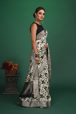 Shop beautiful light grey floral print tussar Benarasi saree online in USA with zari border. Be a vision of style and elegance at parties and special occasions in beautiful designer sarees, embroidered sarees, printed sarees, satin saris from Pure Elegance Indian fashion store in USA.-side