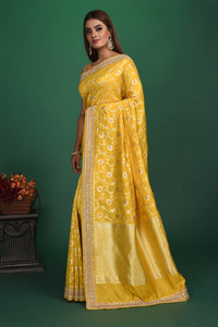 Buy stunning yellow Benarasi georgette saree online in USA with embroidered border. Be a vision of style and elegance at parties and special occasions in beautiful designer sarees, embroidered sarees, printed sarees, satin saris from Pure Elegance Indian fashion store in USA.-full view