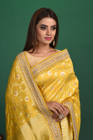 Buy stunning yellow Benarasi georgette saree online in USA with embroidered border. Be a vision of style and elegance at parties and special occasions in beautiful designer sarees, embroidered sarees, printed sarees, satin saris from Pure Elegance Indian fashion store in USA.-closeup