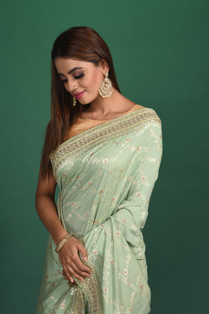 Buy beautiful pastel green Benarasi saree online in USA with embroidered border. Be a vision of style and elegance at parties and special occasions in beautiful designer sarees, embroidered sarees, printed sarees, satin saris from Pure Elegance Indian fashion store in USA.-closeup