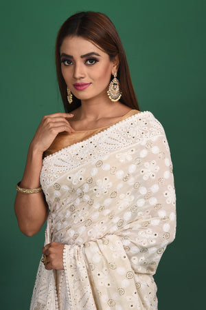 Buy beautiful cream Lucknowi georgette saree online in USA. Be a vision of style and elegance at parties and special occasions in beautiful designer sarees, embroidered sarees, printed sarees, satin saris from Pure Elegance Indian fashion store in USA.-closeup