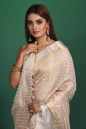 Shop beautiful cream tissue silk striped saree online in USA with designer blouse. Be a vision of style and elegance at parties and special occasions in beautiful designer sarees, embroidered sarees, printed sarees, satin saris from Pure Elegance Indian fashion store in USA.-closeup