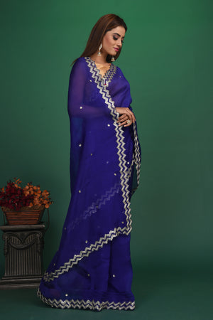 Buy beautiful royal blue embroidered organza saree online in USA. Be a vision of style and elegance at parties and special occasions in beautiful designer sarees, embroidered sarees, printed sarees, satin saris from Pure Elegance Indian fashion store in USA.-side