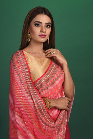 Shop stunning pink striped sequin georgette saree online in USA. Be a vision of style and elegance at parties and special occasions in beautiful designer sarees, embroidered sarees, printed sarees, satin saris from Pure Elegance Indian fashion store in USA.-closeup