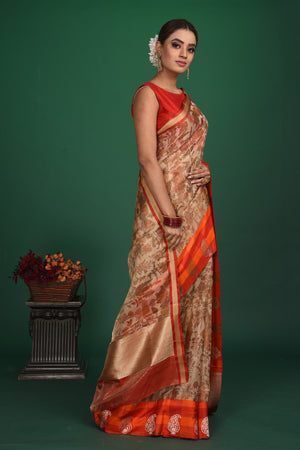 Buy beautiful beige printed Kanjeevaram saree online in USA with red and orange border. Be a vision of style and elegance at parties and special occasions in beautiful designer sarees, embroidered sarees, printed sarees, satin saris from Pure Elegance Indian fashion store in USA.-side