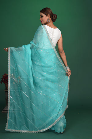 Buy stunning turquoise blue embroidered organza saree online in USA. Be a vision of style and elegance at parties and special occasions in beautiful designer sarees, embroidered sarees, printed sarees, satin saris from Pure Elegance Indian fashion store in USA.-back