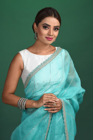 Buy stunning turquoise blue embroidered organza saree online in USA. Be a vision of style and elegance at parties and special occasions in beautiful designer sarees, embroidered sarees, printed sarees, satin saris from Pure Elegance Indian fashion store in USA.-closeup