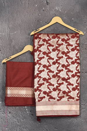 Shop this ethnic deep maroon banarasi silk saree online in USA with zari work which is crafted with  heavy golden zari beautified border. A Beautiful Handloom Banarasi Saree adorned with amazing floral pattern and by skilled weaver of Banaras with elegance and grace, this saree is definitely the epitome of beauty. Style this banarasi silk saree from Pure Elegance Indian fashion store in USA.- Unstitched blouse.