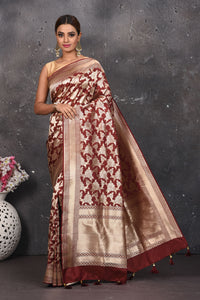 Shop this ethnic deep maroon banarasi silk saree online in USA with zari work which is crafted with  heavy golden zari beautified border. A Beautiful Handloom Banarasi Saree adorned with amazing floral pattern and by skilled weaver of Banaras with elegance and grace, this saree is definitely the epitome of beauty. Style this banarasi silk saree from Pure Elegance Indian fashion store in USA.- Full view with folded hands.