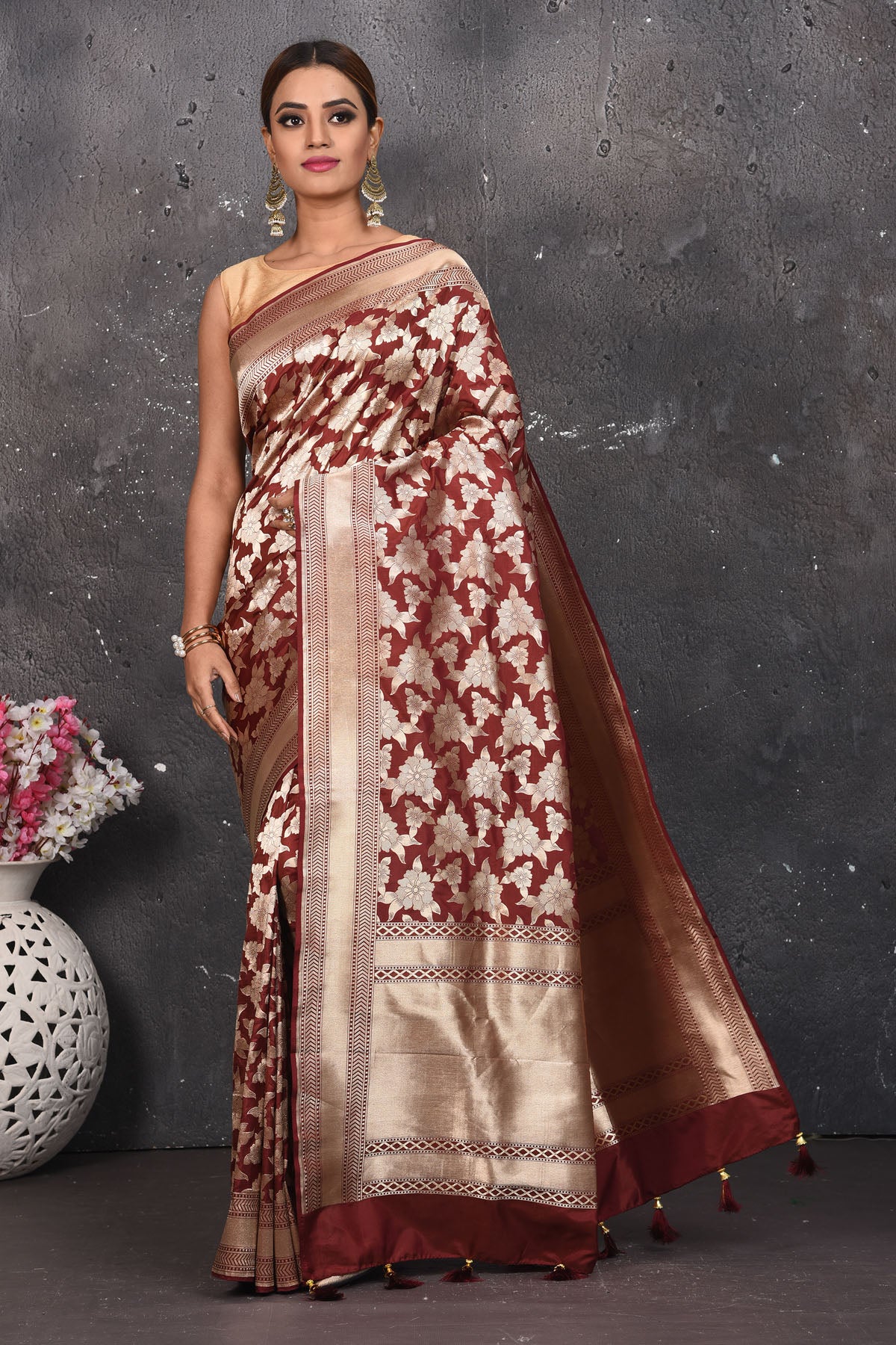 Shop this ethnic deep maroon banarasi silk saree online in USA with zari work which is crafted with  heavy golden zari beautified border. A Beautiful Handloom Banarasi Saree adorned with amazing floral pattern and by skilled weaver of Banaras with elegance and grace, this saree is definitely the epitome of beauty. Style this banarasi silk saree from Pure Elegance Indian fashion store in USA.- Full view with open pallu.