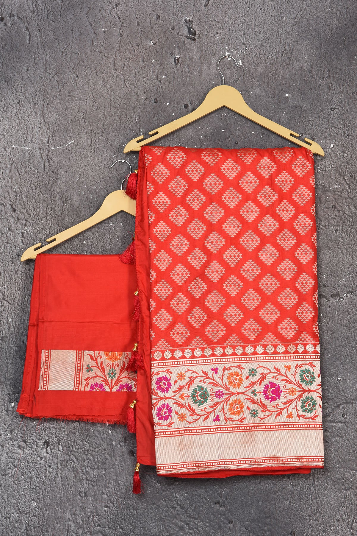Shop this exquisite coral red silk brocade handloom banarasi saree online in USA. The sari comes with a graceful border with handmade latkan and colourful floral pattern all over. Buy this brocade banarsi sari with zari work from Pure Elegance Indian fashion store in USA and style it with your best pair of heels, gold or Moti necklace and a potli bag for the perfect look.- Unstitched blouse.