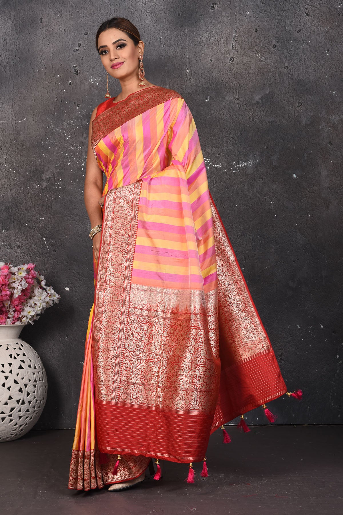 Buy this classy red banarasi silk brocade woven diagonal stripes and floral saree online in USA which has beautiful zari work all over the heavy border and end with handmade latkan. Pair this royal banarasi handloom brocade woven saree with your designer blouse and a potli bag from Pure Elegance Indian fashion store in USA.- Full view with open pallu.