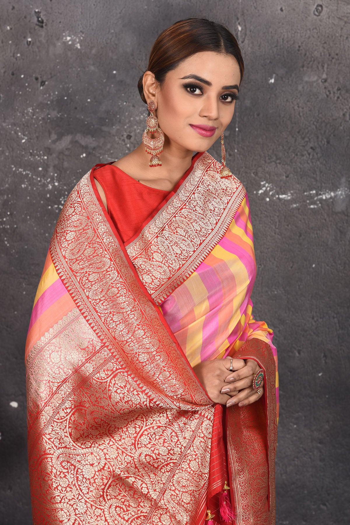 Buy this classy red banarasi silk brocade woven diagonal stripes and floral saree online in USA which has beautiful zari work all over the heavy border and end with handmade latkan. Pair this royal banarasi handloom brocade woven saree with your designer blouse and a potli bag from Pure Elegance Indian fashion store in USA.- Close up.