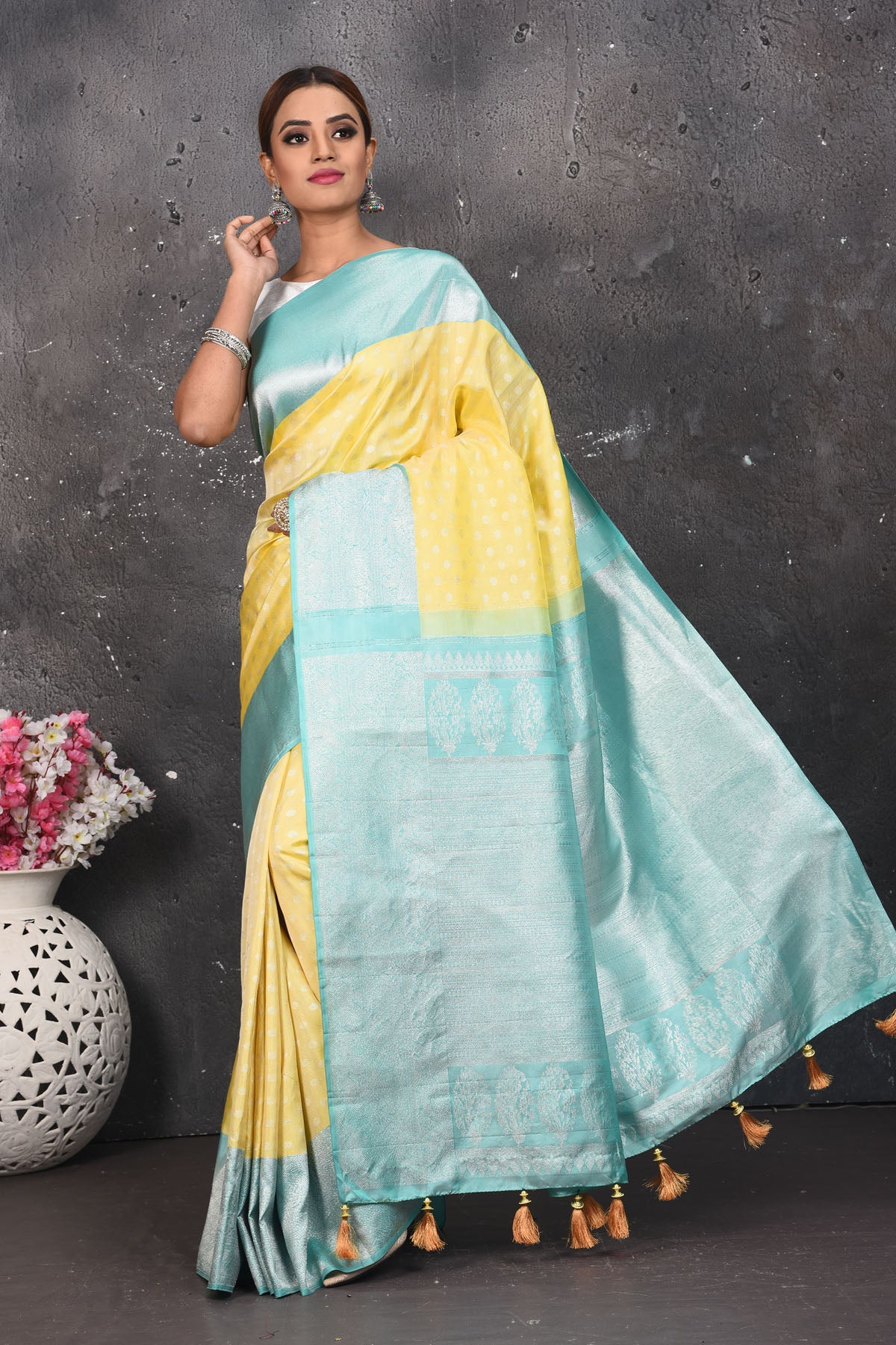 Shop this royal handwoven pure kanchiresham saree in lemon yellow with a firozi blue pallu and buti work online in USA. Presenting Enchanting Yet Breathable Organic Banarasi Saree Made from Kanjivaram silk. Drape yourself in this beautiful banarasi saree from Pure Elegance Indian Fashion Store in USA with Zari woven Border with a potli bag and high heels for a flawless look.- Full view.