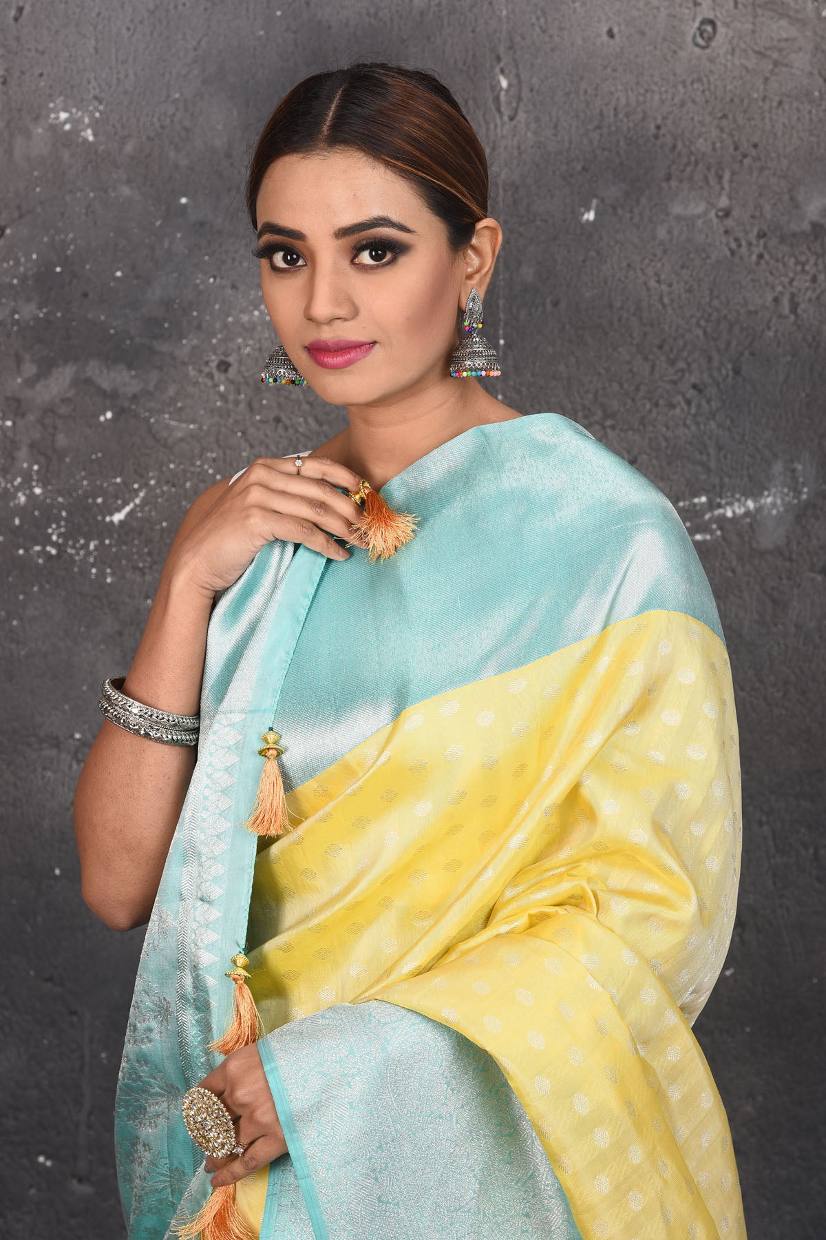 Shop this royal handwoven pure kanchiresham saree in lemon yellow with a firozi blue pallu and buti work online in USA. Presenting Enchanting Yet Breathable Organic Banarasi Saree Made from Kanjivaram silk. Drape yourself in this beautiful banarasi saree from Pure Elegance Indian Fashion Store in USA with Zari woven Border with a potli bag and high heels for a flawless look.- Close up.
