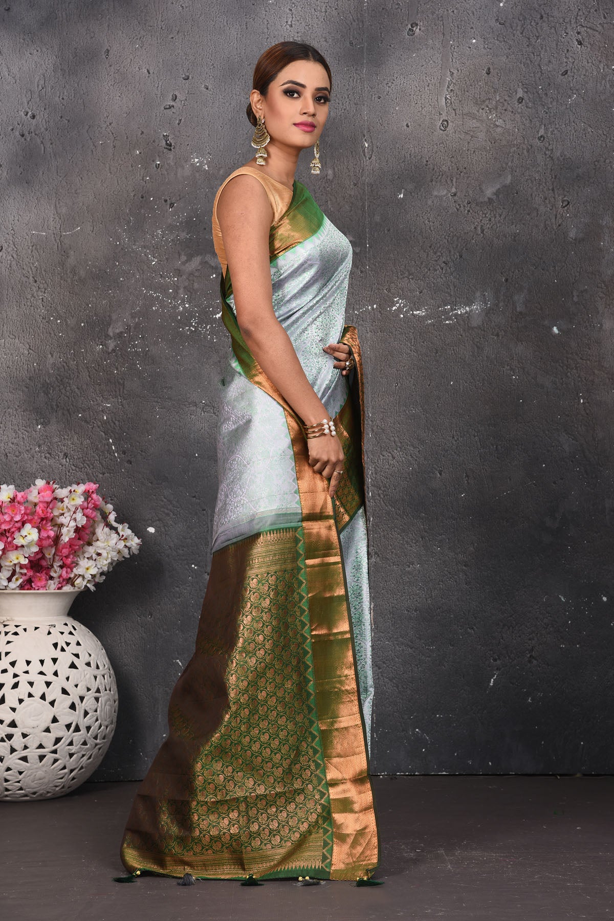 Buy beautiful handloom kanchipuram silk saree adorned with antique zari buta work online in USA which has crafted by skilled weaver with elegance and grace, this saree is definitely the epitome of beauty and a must have in your collection. Buy designer handwoven kanchipuram sari with any blouse from Pure Elegance Indian saree store in USA.- Side view.