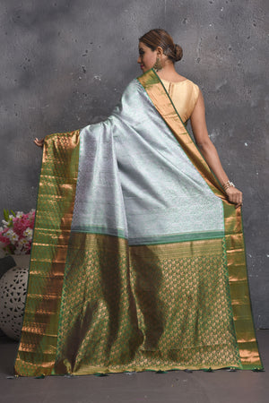 Buy beautiful handloom kanchipuram silk saree adorned with antique zari buta work online in USA which has crafted by skilled weaver with elegance and grace, this saree is definitely the epitome of beauty and a must have in your collection. Buy designer handwoven kanchipuram sari with any blouse from Pure Elegance Indian saree store in USA.- Back view with open pallu.
