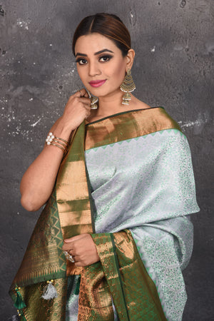 Buy beautiful handloom kanchipuram silk saree adorned with antique zari buta work online in USA which has crafted by skilled weaver with elegance and grace, this saree is definitely the epitome of beauty and a must have in your collection. Buy designer handwoven kanchipuram sari with any blouse from Pure Elegance Indian saree store in USA.- Close up.