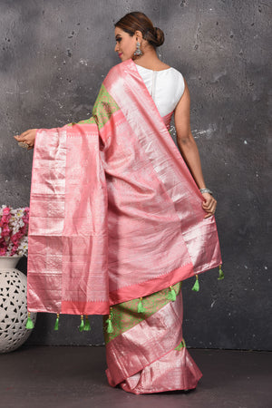 Buy this royal olive green-pink handloom kanchipuram saree with buta zari work online in USA. An enchanting silk saree with scintillating palla and border. This kanchipuram silk brings the charm and simplicity of this olive green saree with border and pallu with the delegate buta work with silver zari. Shop this designer silk sari from Pure Elegance Indian fashion store in USA.- Back view with open pallu.