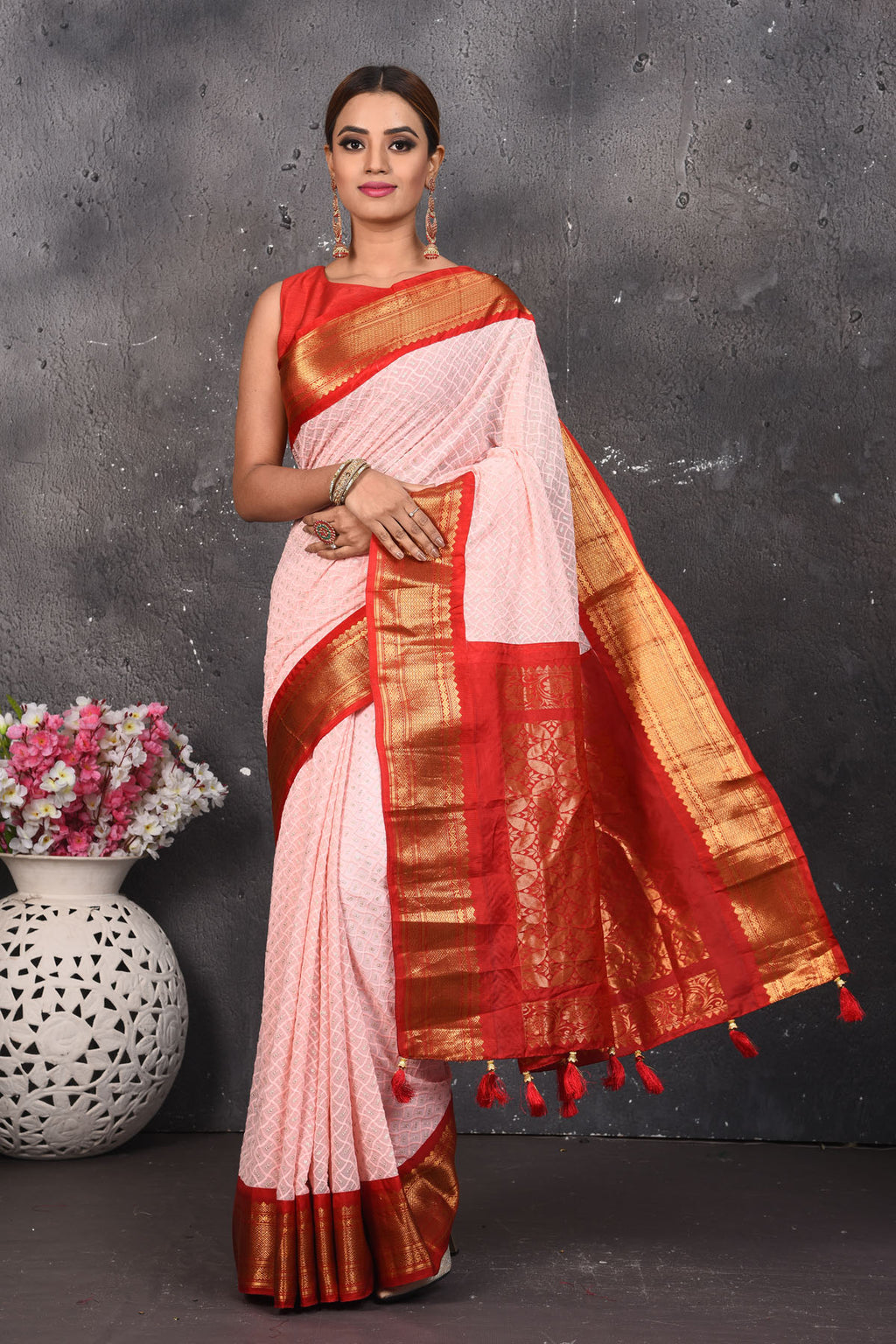 Shop this elegant peach pink sequins georgette saree with red-golden zari border online in USA. Create and establish a smashing influence on everybody by carrying this designer sequin georgette saree with your designer blouse. Shop designer sequins georgette with heavy border from Pure Elegance Indian saree store in USA.- Full view with folded hands.