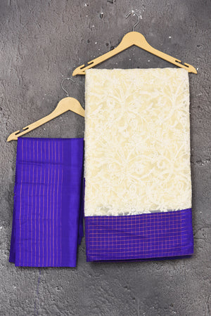 Buy this exquisite Off-white and violet chiffon box printed saree with chikankari hand-embroidered online in USA. Style this lucknawi sari with a potli bag and high heels for a flawless look which has gorgeous heavy pallu with dull-gold zari work. This saree is definitely the epitome of beauty and a must have in your collection. Buy designer handwoven chikankari sari with any blouse from Pure Elegance Indian saree store in USA.- Unstitched blouse.