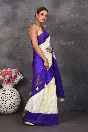 Buy this exquisite Off-white and violet chiffon box printed saree with chikankari hand-embroidered online in USA. Style this lucknawi sari with a potli bag and high heels for a flawless look which has gorgeous heavy pallu with dull-gold zari work. This saree is definitely the epitome of beauty and a must have in your collection. Buy designer handwoven chikankari sari with any blouse from Pure Elegance Indian saree store in USA.-Side view.