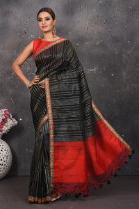 Buy this elegant black saree leheriya with gota patti work online in USA. Style this designer sari which has a beautiful red border with golden lace at the edge with a potli bag and high heels. Add designer gota patti sari to your collection from Pure Elegance Indian saree store in USA.- Full view with open pallu.