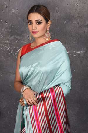 Shop beautiful light blue Mashru silk saree online in USA with striped pallu. Be the center of attraction on special occasions in stunning silk sarees, handloom sarees, embroidered sarees, designer sarees, Bollywood sarees from Pure Elegance Indian fashion store in USA.-closeup