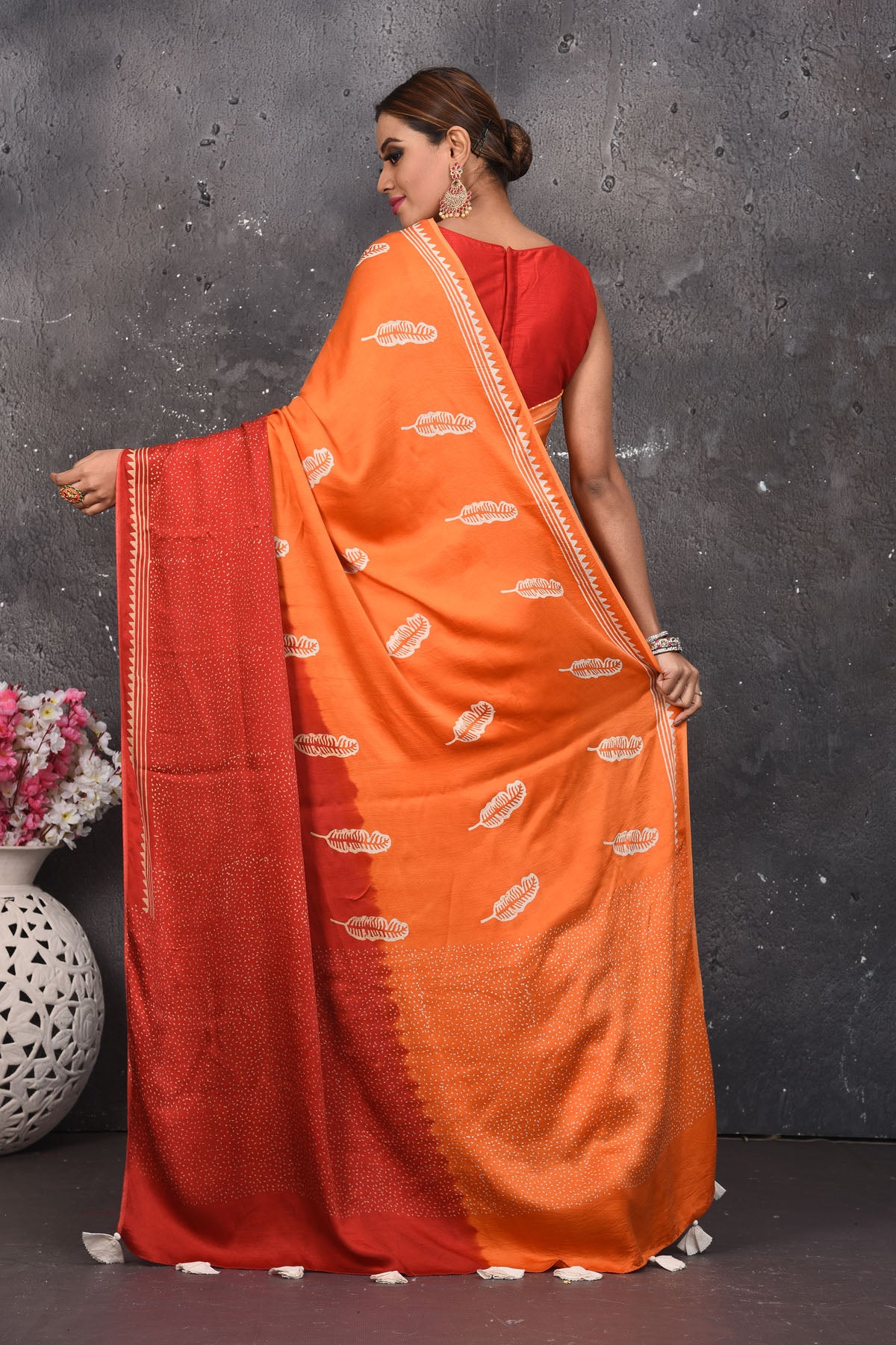 Shop stunning orange and red printed modal silk sari online in USA. Be the center of attraction on special occasions in stunning silk sarees, handloom sarees, embroidered sarees, designer sarees, Bollywood sarees from Pure Elegance Indian fashion store in USA.-back