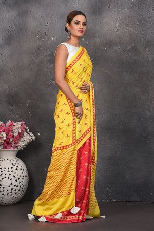 Shop stunning yellow and red printed modal silk sari online in USA. Be the center of attraction on special occasions in stunning silk sarees, handloom sarees, embroidered sarees, designer sarees, Bollywood sarees from Pure Elegance Indian fashion store in USA.-side
