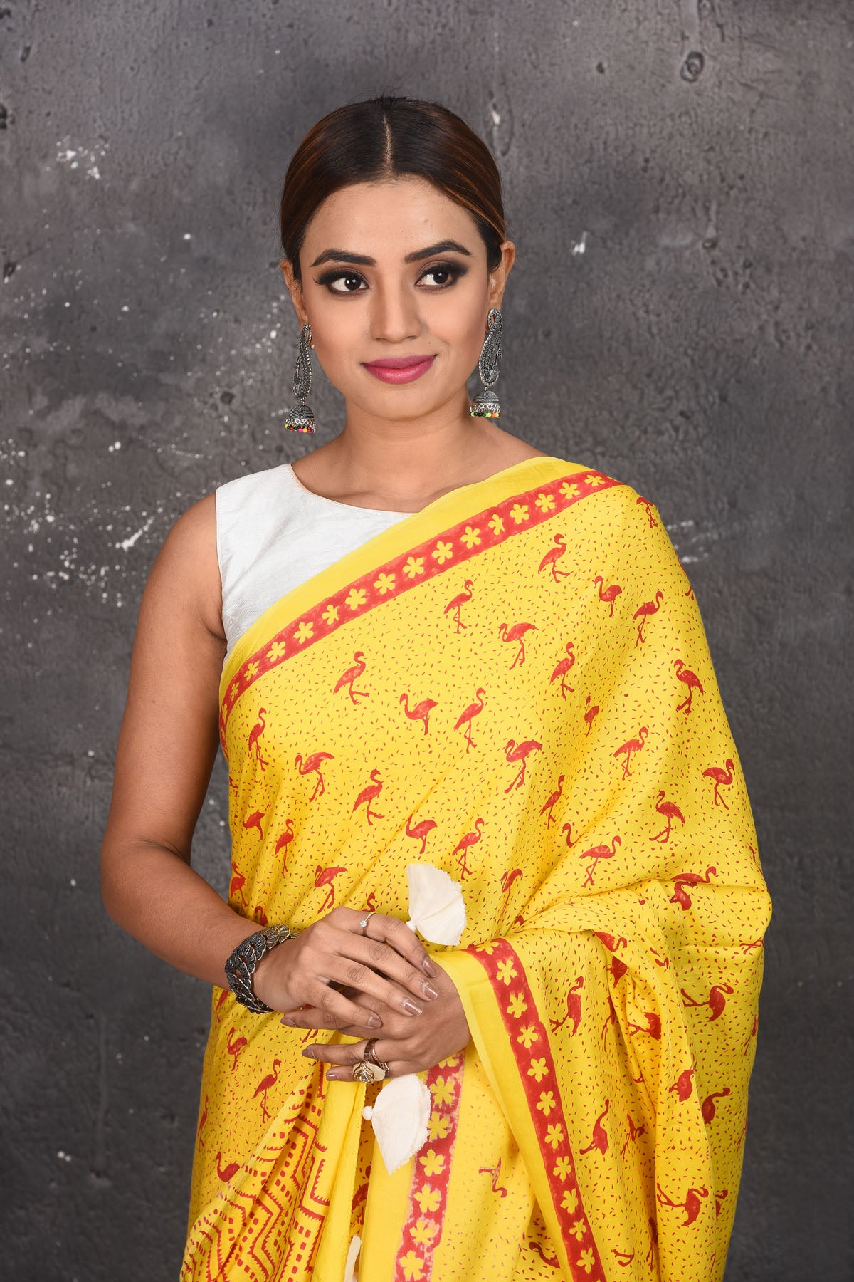 Shop stunning yellow and red printed modal silk sari online in USA. Be the center of attraction on special occasions in stunning silk sarees, handloom sarees, embroidered sarees, designer sarees, Bollywood sarees from Pure Elegance Indian fashion store in USA.-closeup