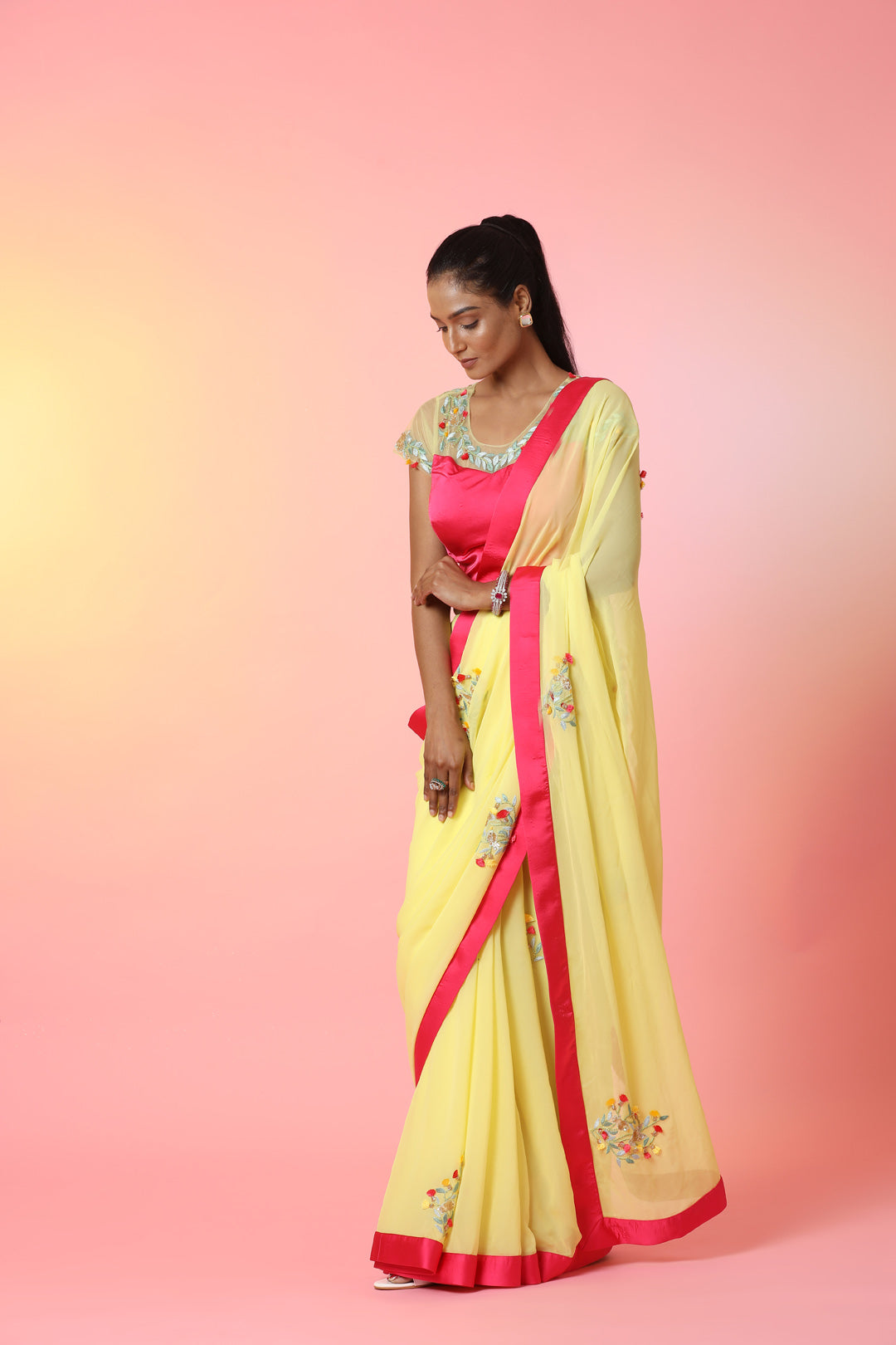 Shop beautiful yellow embroidered georgette saree online in USA with pink saree blouse. Look perfect in ethnic style on special occasions in beautiful designer sarees, embroidered sarees, party sarees, Bollywood sarees, handloom sarees from Pure Elegance Indian saree store in USA.-left