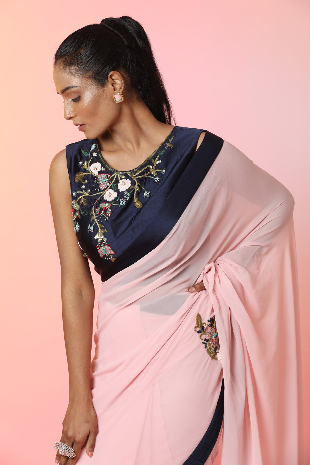 Buy beautiful powder pink embroidered georgette saree online in USA with blue border. Look perfect in ethnic style on special occasions in beautiful designer sarees, embroidered sarees, party sarees, Bollywood sarees, handloom sarees from Pure Elegance Indian saree store in USA.-closeup