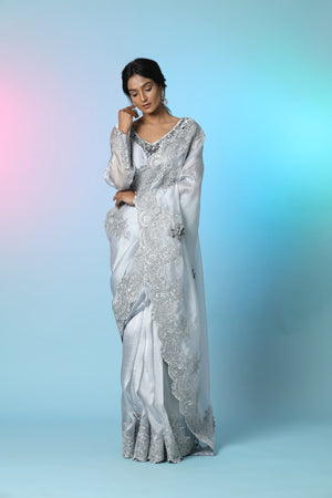 Buy beautiful light grey tissue georgette saree online in USA with saree blouse. Look perfect in ethnic style on special occasions in beautiful designer sarees, embroidered sarees, party sarees, Bollywood sarees, handloom sarees from Pure Elegance Indian saree store in USA.-front