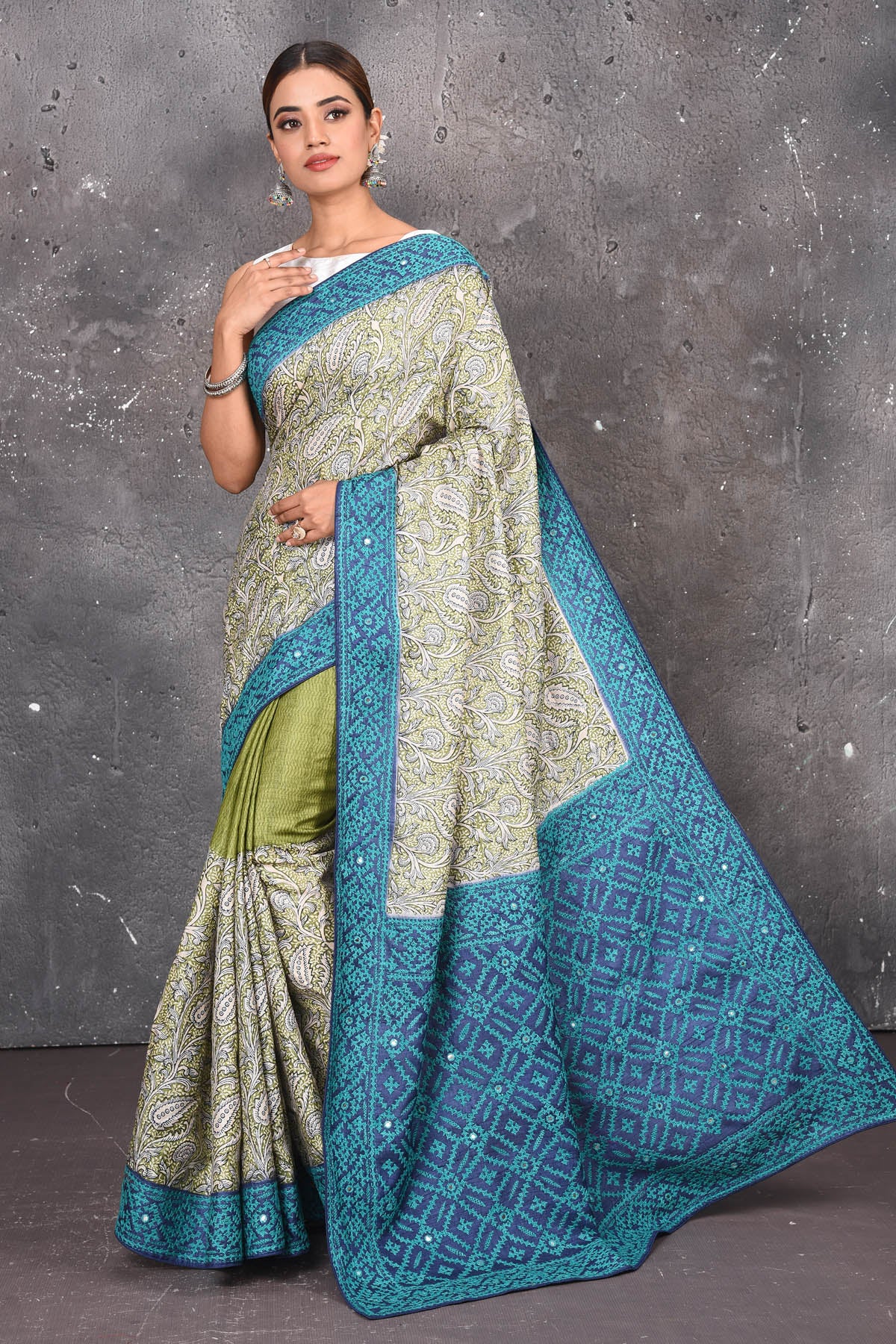 Buy this exquisite hand block printed designer saree in silver-grey and blue color with kutch work online in USA.  Add this hand-embroidered tussar sari which has made up of pure tussar silk. These sarees can be worn for any occasion - It carries a class. Buy this tussar sari with any blouse from Pure Elegance Indian saree store in USA.- Full view with open pallu.
