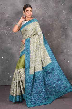 Buy this exquisite hand block printed designer saree in silver-grey and blue color with kutch work online in USA.  Add this hand-embroidered tussar sari which has made up of pure tussar silk. These sarees can be worn for any occasion - It carries a class. Buy this tussar sari with any blouse from Pure Elegance Indian saree store in USA.- Full view.