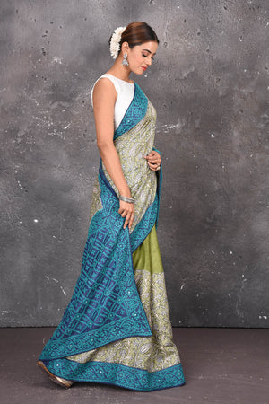 Buy this exquisite hand block printed designer saree in silver-grey and blue color with kutch work online in USA.  Add this hand-embroidered tussar sari which has made up of pure tussar silk. These sarees can be worn for any occasion - It carries a class. Buy this tussar sari with any blouse from Pure Elegance Indian saree store in USA.- Side view.